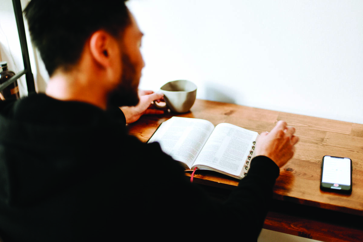 man reading the bible