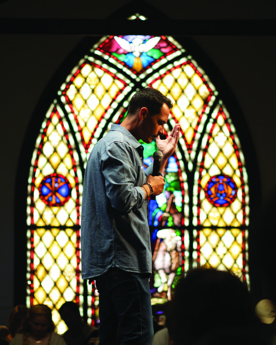 preacher praying at church