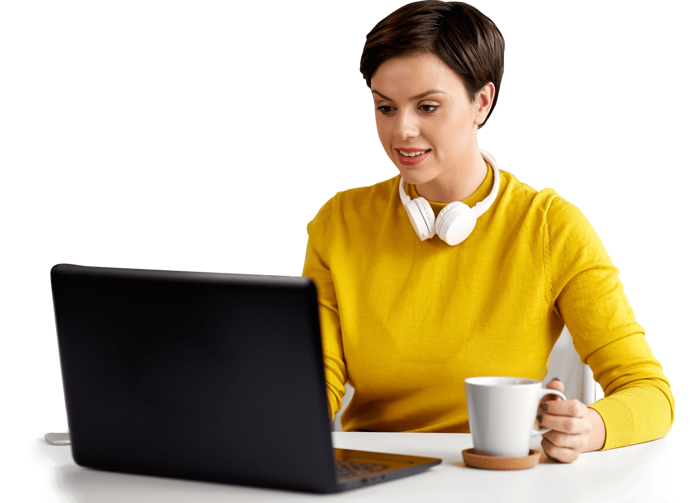 Woman holding coffee mug and using a laptop