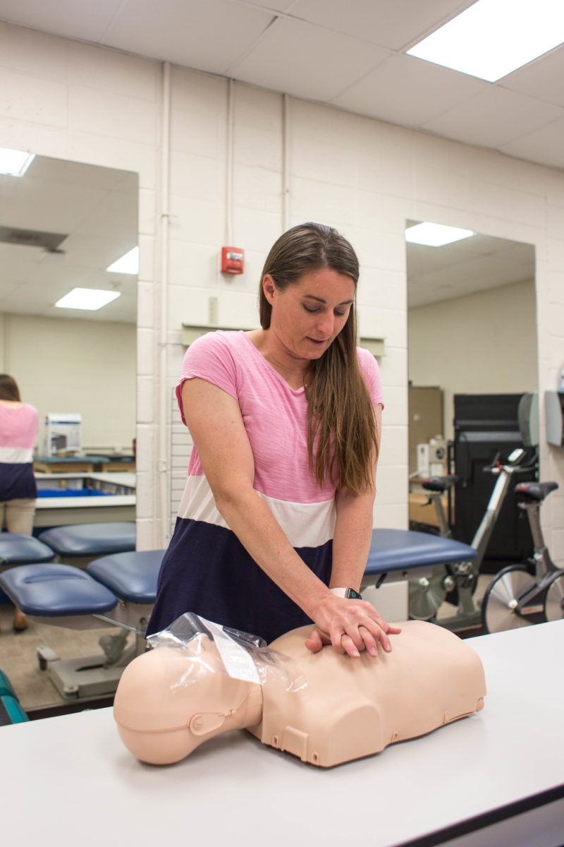 Dr. Monk demonstrates CPR on a dummy