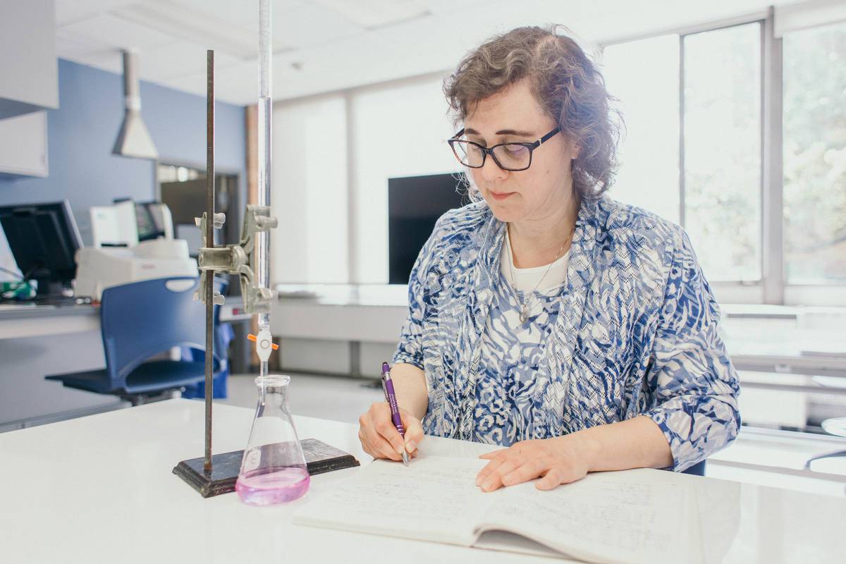 Dr. Pecoraro works with a purple solution in the lab