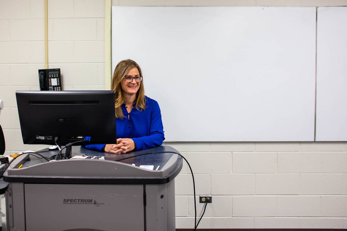 Dr. Stanculescu teaches from a classroom lectern