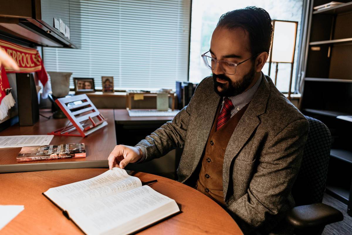 Dr. do Vale reads a Bible in his office