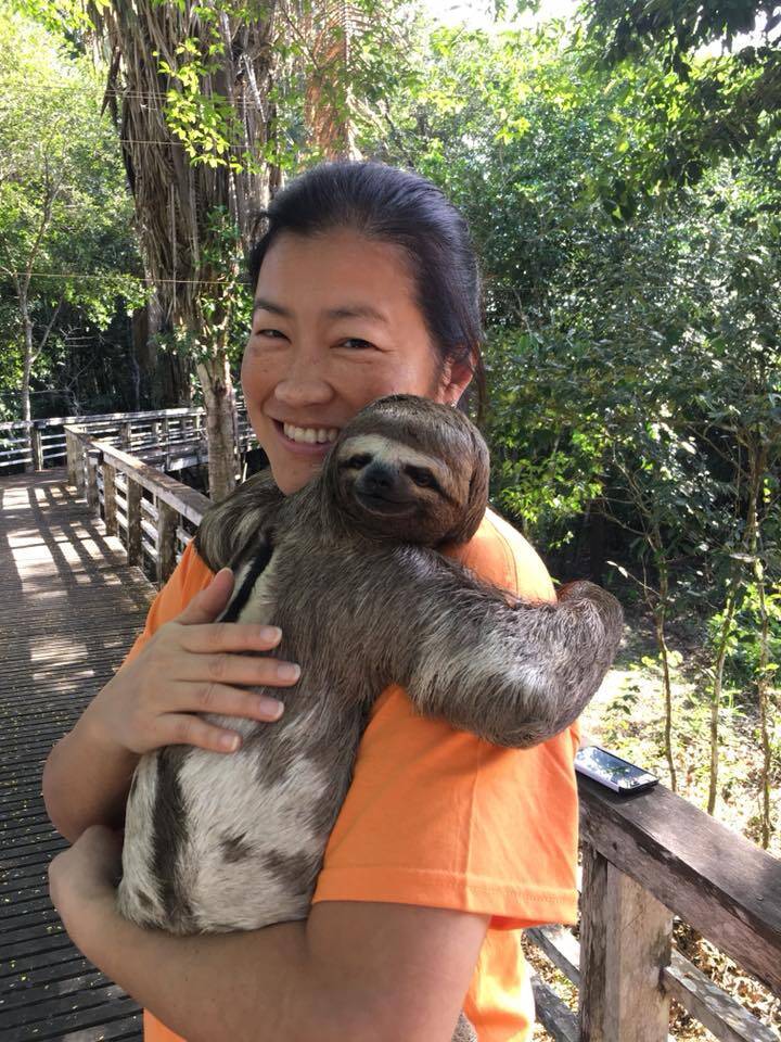 Peggy holding a sloth in the Amazon Jungle