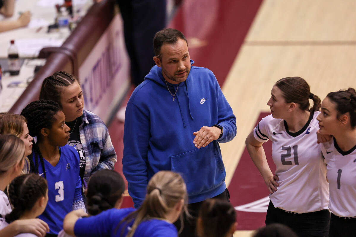 Coach Luke Ward instructing the team during a time out. 