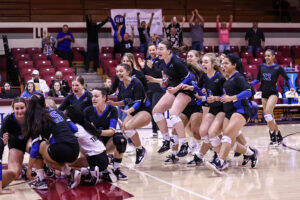 TIU Trojans celebrate on the court. 