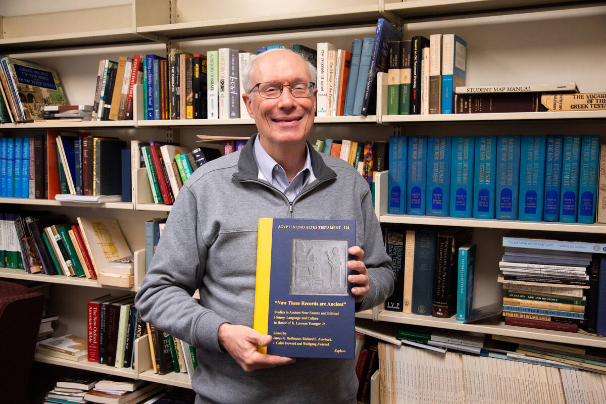 Dr. Younger holding his festschrift in his office. 